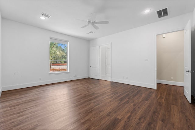 empty room with ceiling fan and dark wood-type flooring