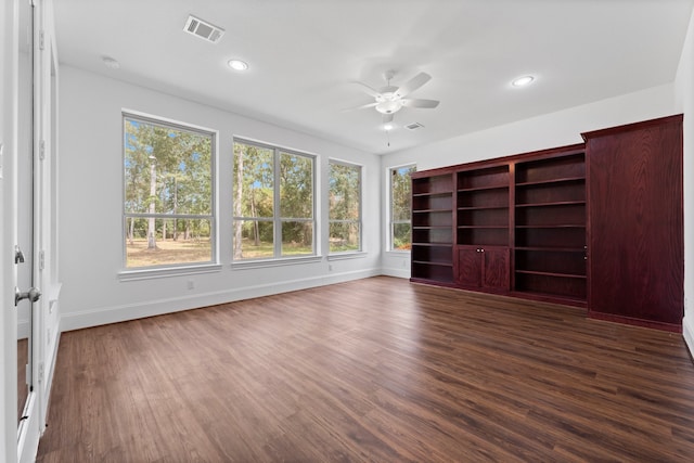 unfurnished bedroom featuring ceiling fan and dark hardwood / wood-style flooring