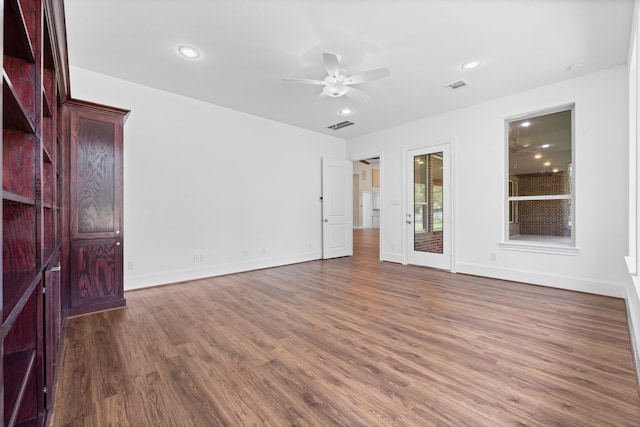 unfurnished room featuring ceiling fan and dark wood-type flooring