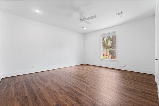 spare room with ceiling fan and dark wood-type flooring