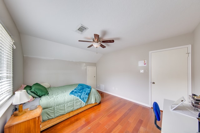 bedroom featuring wood-type flooring, lofted ceiling, and ceiling fan