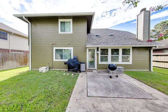 back of property featuring a yard and a patio area