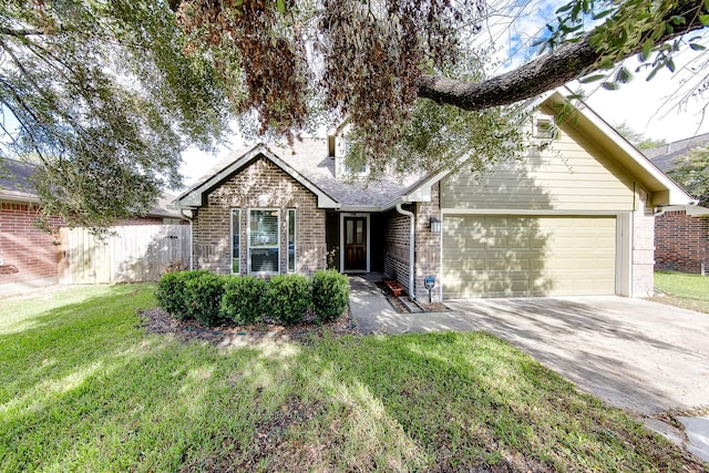 view of front of property with driveway, a front yard, fence, brick siding, and a garage