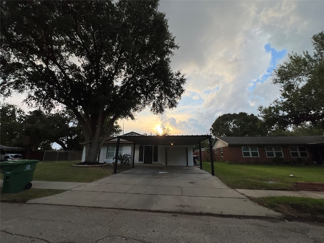 ranch-style home with a carport and a yard