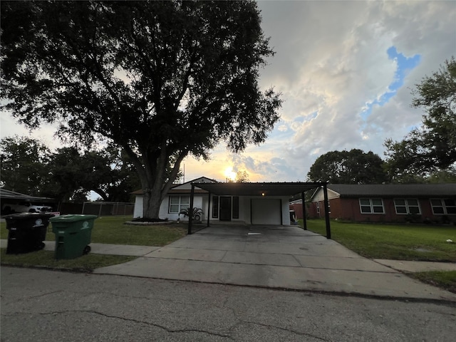 ranch-style house with a carport and a yard