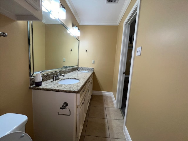 bathroom with ornamental molding, vanity, toilet, and tile patterned floors