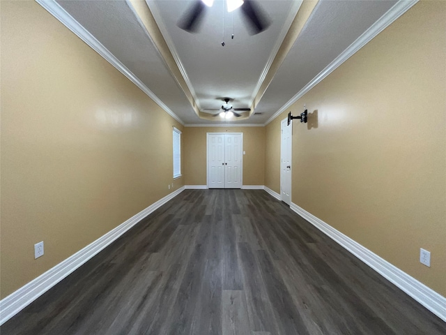 unfurnished room with a barn door, crown molding, dark hardwood / wood-style floors, and ceiling fan