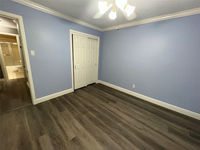 unfurnished bedroom with ornamental molding, a closet, ceiling fan, and dark wood-type flooring