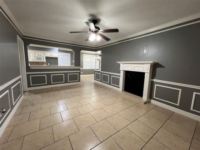 unfurnished living room featuring ceiling fan and crown molding