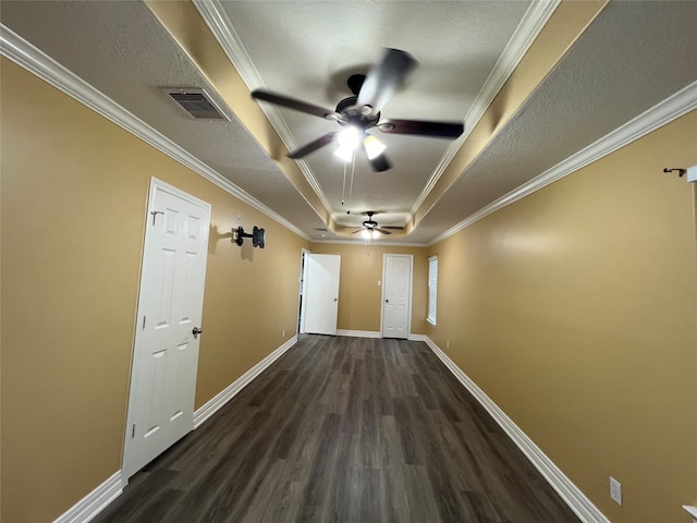 hallway featuring a textured ceiling, a raised ceiling, crown molding, and dark hardwood / wood-style flooring