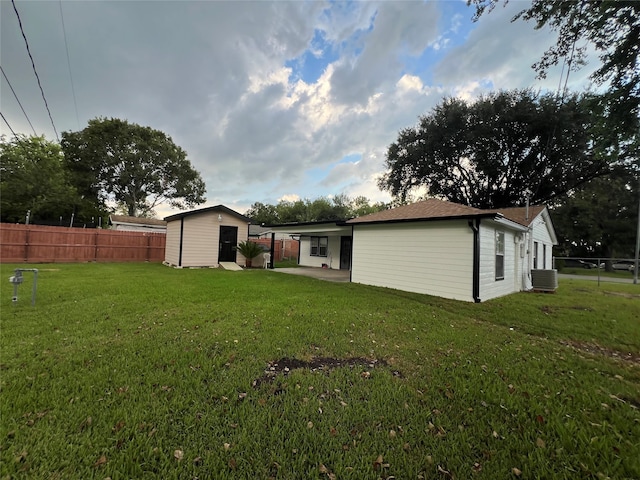 exterior space with a storage shed, central AC unit, and a patio area