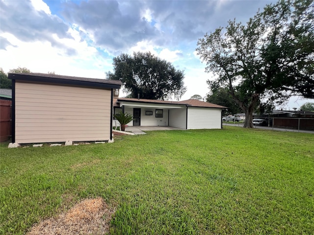 back of house featuring a patio area and a yard