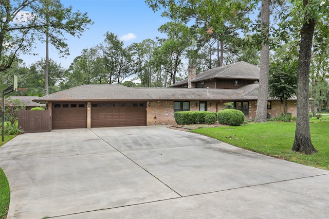 view of front facade with a garage and a front lawn