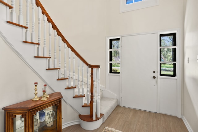 foyer entrance with light hardwood / wood-style flooring and a wealth of natural light