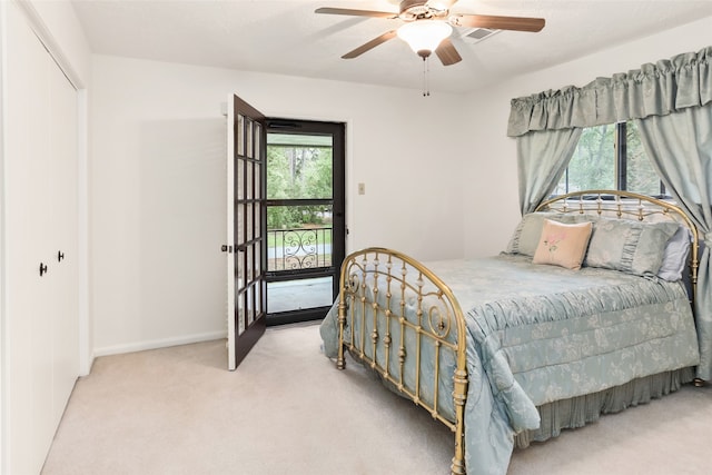 bedroom featuring light carpet, a closet, and ceiling fan