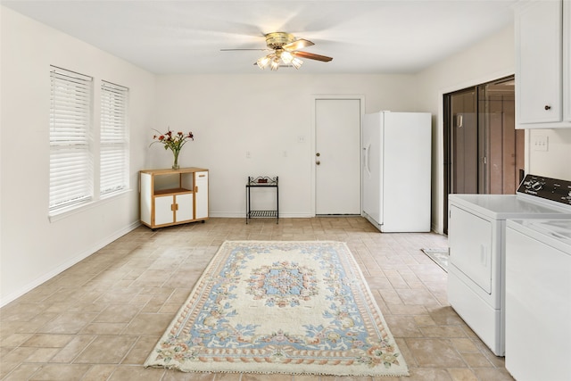 interior space with washer and clothes dryer, ceiling fan, white refrigerator with ice dispenser, and white cabinets