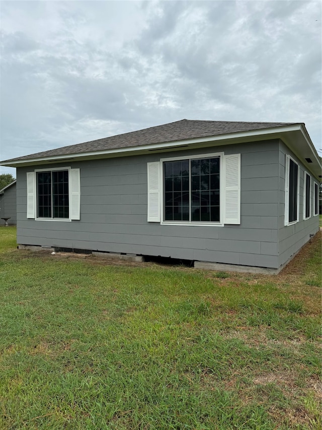 view of side of property with a yard