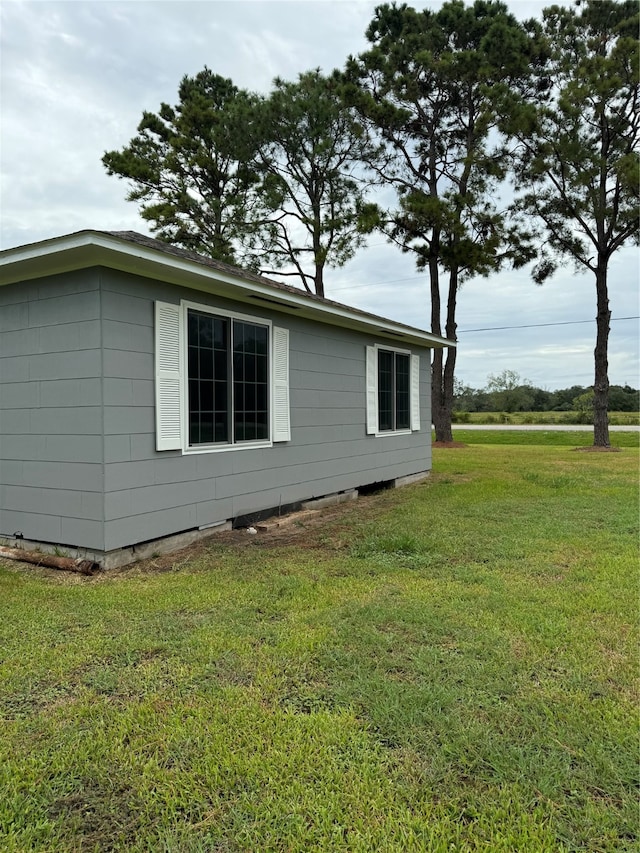 view of side of home featuring a yard