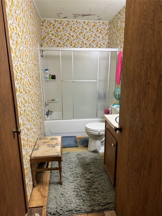 full bathroom with bath / shower combo with glass door, vanity, and toilet