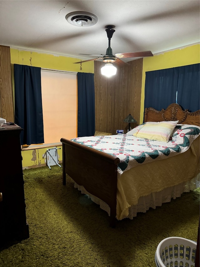 bedroom with ornamental molding, carpet, and ceiling fan