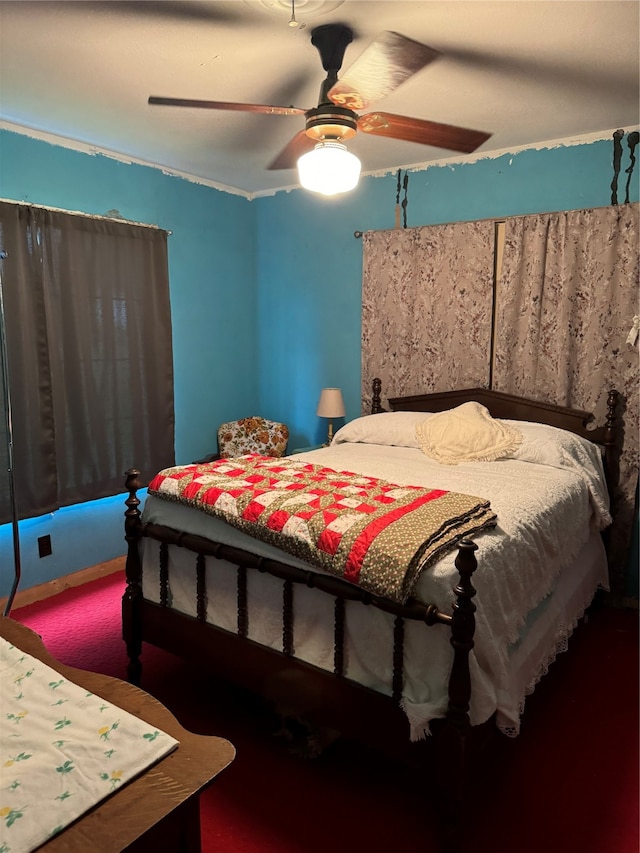 carpeted bedroom featuring ornamental molding and ceiling fan