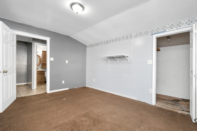 interior space with carpet and vaulted ceiling