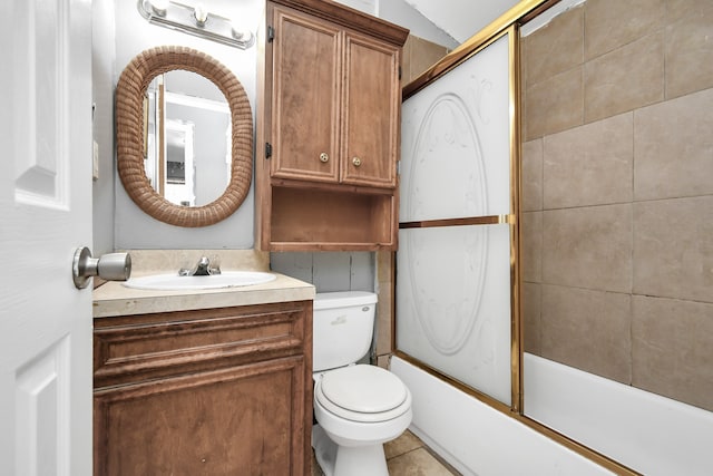 full bathroom with shower / bath combination with glass door, vaulted ceiling, tile patterned floors, vanity, and toilet