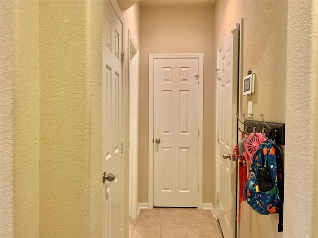 doorway to outside with light tile patterned floors