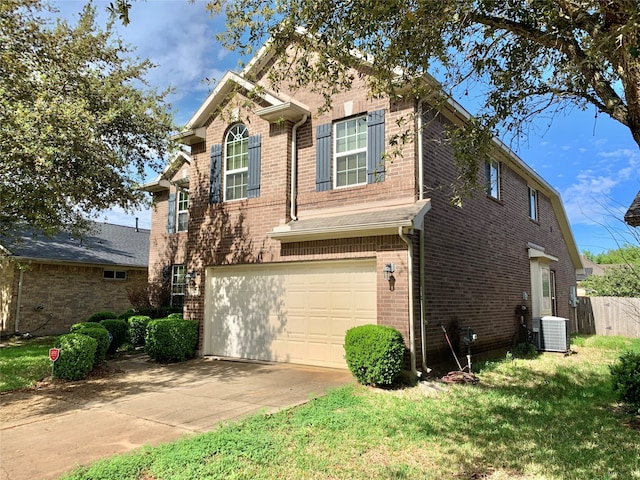 view of front facade with cooling unit, a garage, and a front yard