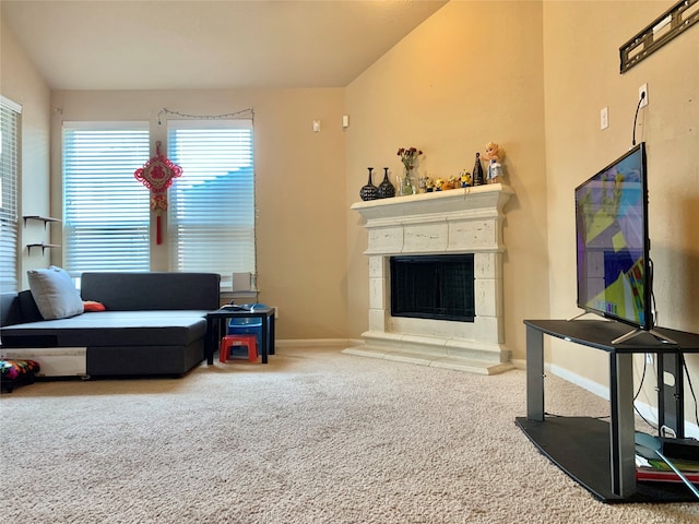 carpeted living room with a tiled fireplace