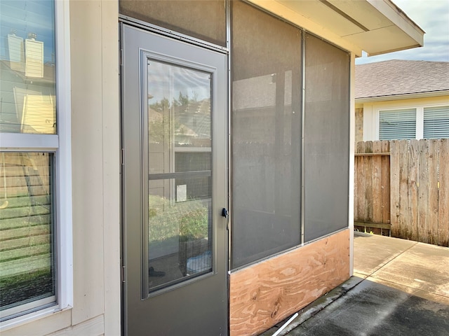 view of exterior entry with a patio