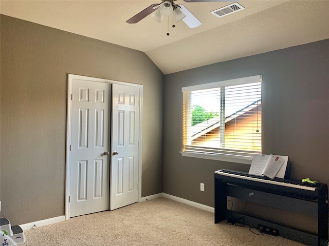 misc room with ceiling fan, light colored carpet, and lofted ceiling