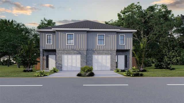 view of front of house featuring a yard and a garage