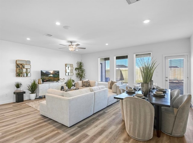 living room with light hardwood / wood-style floors and ceiling fan