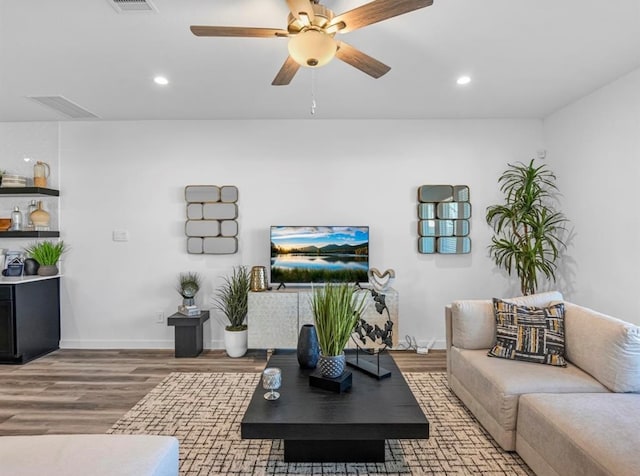 living room featuring ceiling fan and hardwood / wood-style floors