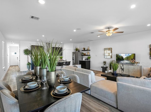 dining room with light wood-type flooring and ceiling fan