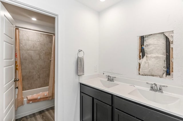 bathroom with shower / bath combination with curtain, hardwood / wood-style flooring, and vanity