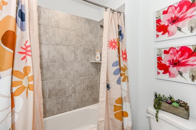 bathroom with shower / bath combo with shower curtain and toilet