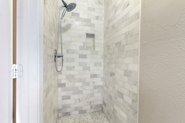 bathroom with a tile shower