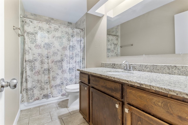 full bathroom with vanity, shower / bath combo with shower curtain, toilet, and tile patterned flooring