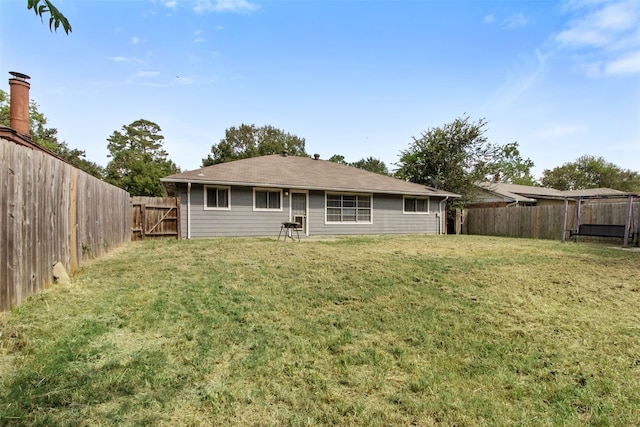 rear view of property with a lawn