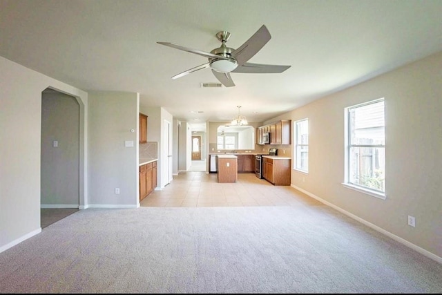 unfurnished living room featuring light carpet and ceiling fan