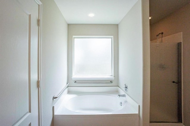 bathroom featuring shower with separate bathtub