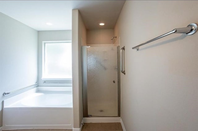 bathroom with independent shower and bath and tile patterned floors