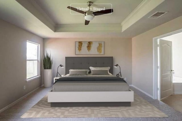 bedroom with ceiling fan, light colored carpet, a raised ceiling, and ornamental molding