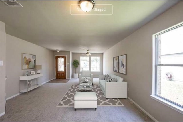 unfurnished living room with ceiling fan and light colored carpet