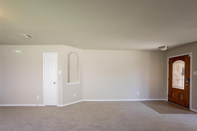 foyer entrance with light colored carpet