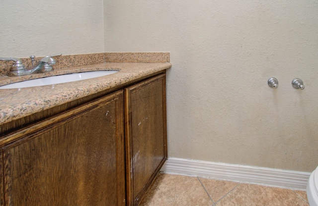 bathroom with vanity, tile patterned flooring, and toilet