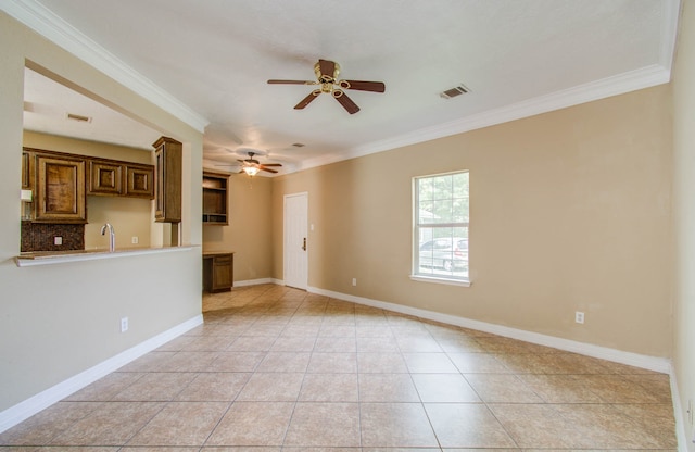 unfurnished living room featuring light tile patterned floors, ornamental molding, sink, and ceiling fan