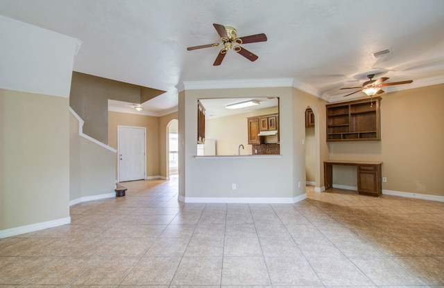 unfurnished living room featuring ceiling fan, light tile patterned flooring, crown molding, and sink